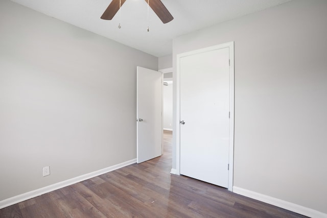 unfurnished bedroom featuring ceiling fan, wood finished floors, and baseboards