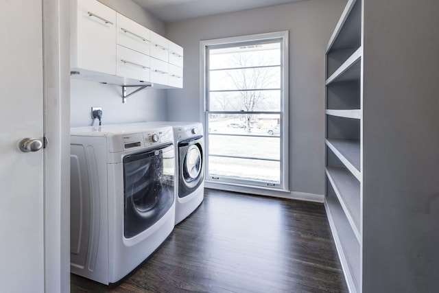 washroom featuring laundry area, washing machine and clothes dryer, dark wood finished floors, and baseboards