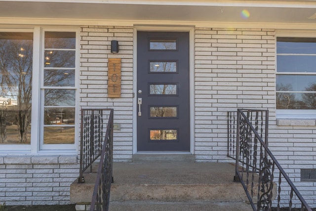 entrance to property with brick siding