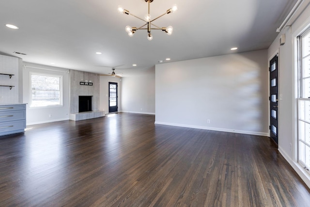 unfurnished living room with recessed lighting, a fireplace, visible vents, baseboards, and dark wood-style floors