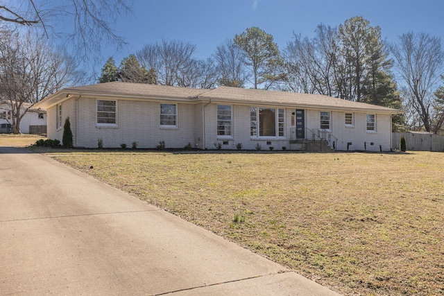 ranch-style house featuring crawl space, fence, a front lawn, and brick siding