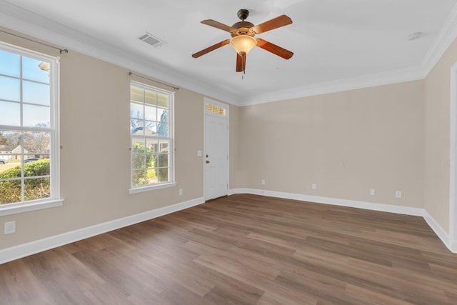 unfurnished room with a healthy amount of sunlight, wood finished floors, and crown molding