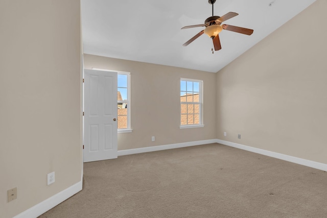 unfurnished room featuring lofted ceiling, ceiling fan, carpet, and baseboards