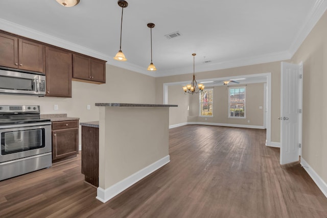 kitchen featuring visible vents, dark wood-style floors, ornamental molding, decorative light fixtures, and stainless steel appliances