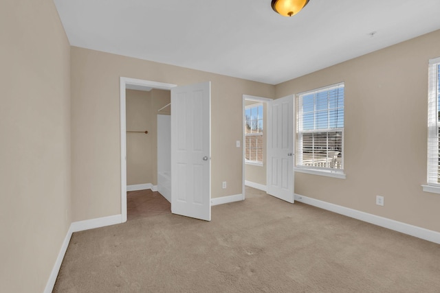 unfurnished bedroom featuring baseboards and carpet flooring