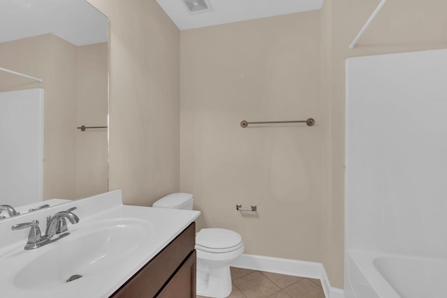 bathroom with tile patterned flooring, toilet, vanity, visible vents, and baseboards