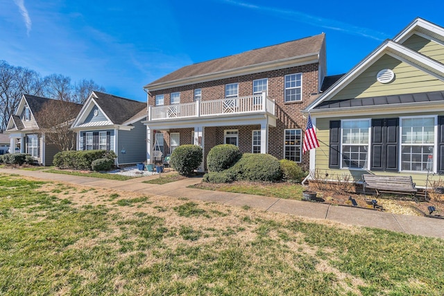 view of front of home featuring brick siding and a front lawn