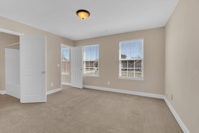 unfurnished bedroom featuring carpet and baseboards