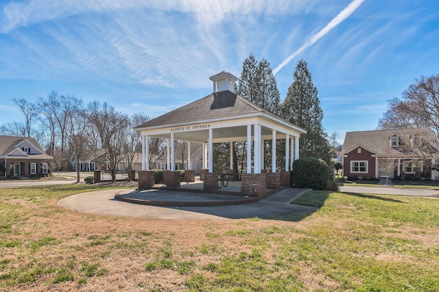 view of property's community with a gazebo and a yard