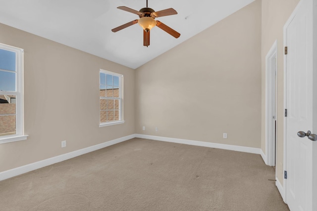 unfurnished room with lofted ceiling, ceiling fan, baseboards, and light colored carpet