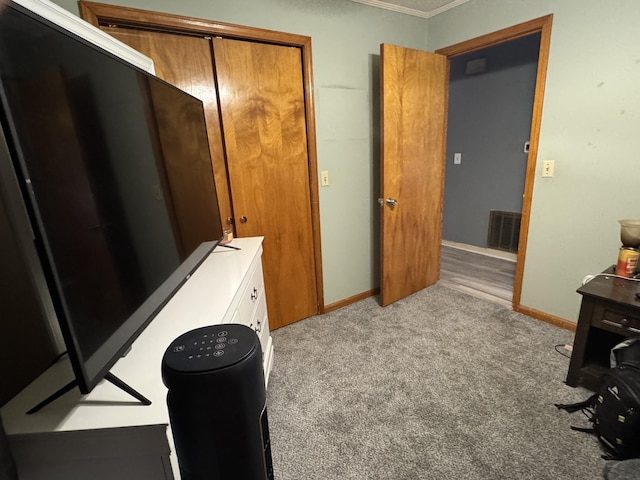 bedroom featuring baseboards, visible vents, a closet, and light colored carpet