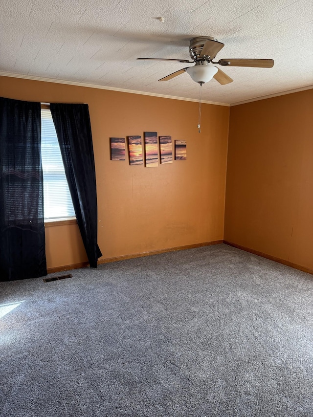 unfurnished room with carpet, crown molding, visible vents, a ceiling fan, and a textured ceiling