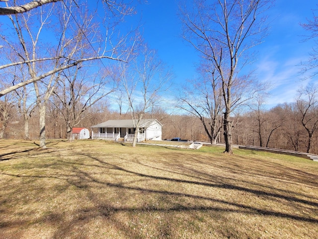 exterior space with covered porch and a front lawn