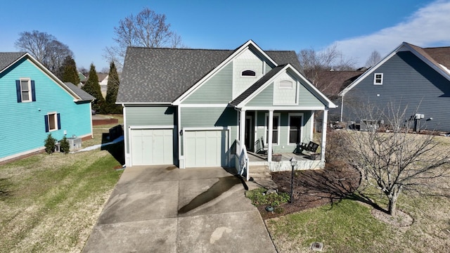 view of front facade featuring driveway, a garage, roof with shingles, covered porch, and a front yard