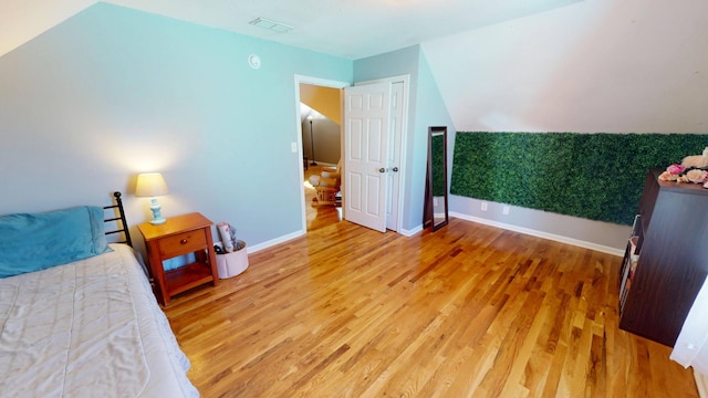 bedroom with visible vents, baseboards, and light wood-style floors