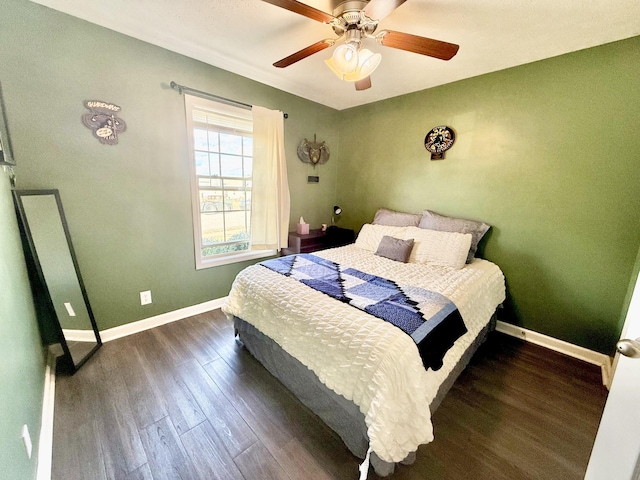 bedroom featuring dark wood-style floors, ceiling fan, and baseboards