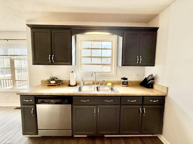 bar featuring dark wood-style floors, baseboards, a sink, and stainless steel dishwasher