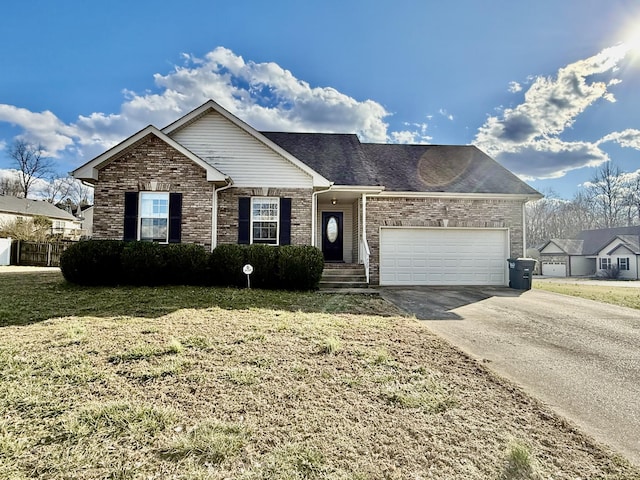 ranch-style house featuring driveway, an attached garage, and a front yard