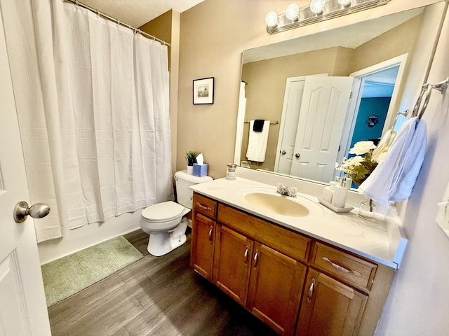 bathroom with toilet, shower / bath combo, wood finished floors, and vanity