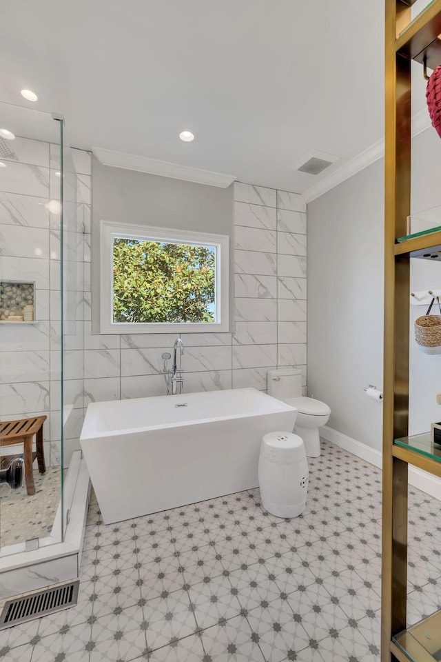 bathroom featuring a stall shower, visible vents, tile walls, and ornamental molding