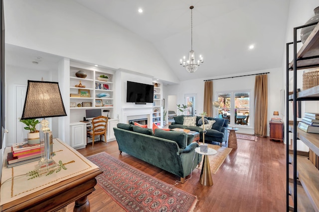 living area with high vaulted ceiling, a fireplace, and wood finished floors