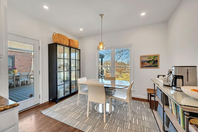 dining space with recessed lighting, baseboards, and wood finished floors