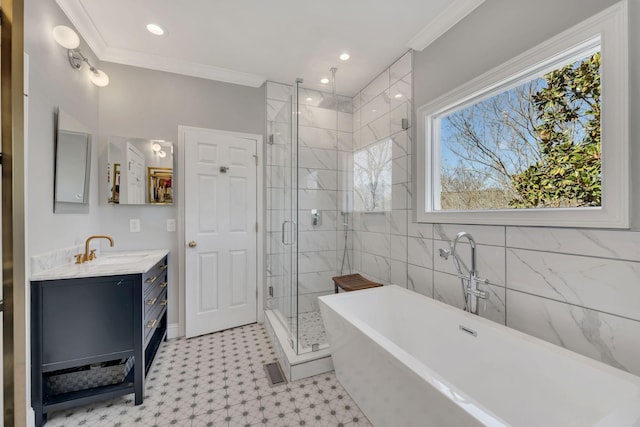 full bath featuring visible vents, ornamental molding, a stall shower, vanity, and a freestanding tub