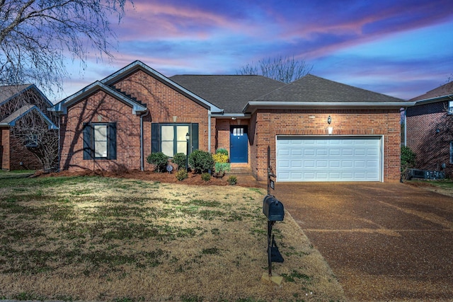 ranch-style house featuring driveway, an attached garage, roof with shingles, and brick siding