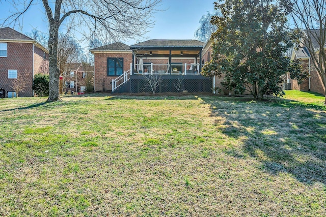 view of front facade featuring a front yard and brick siding