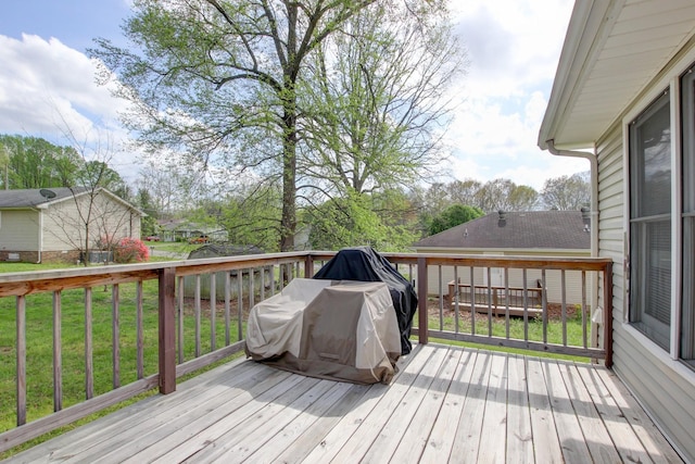 wooden terrace featuring a lawn