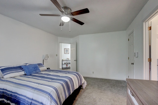 carpeted bedroom with ceiling fan and baseboards