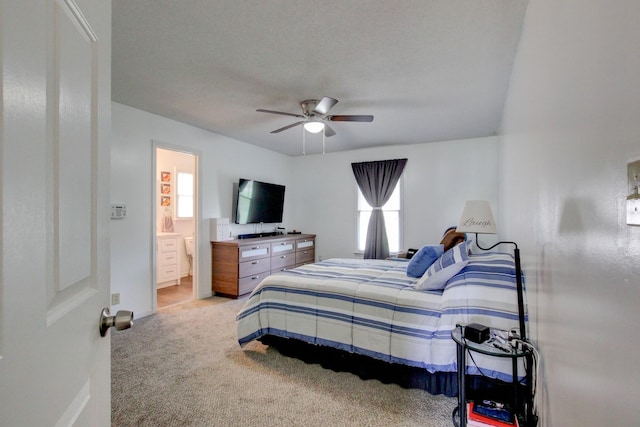 bedroom featuring carpet floors, multiple windows, connected bathroom, and a ceiling fan