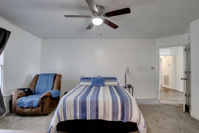 carpeted bedroom with ceiling fan, visible vents, and baseboards