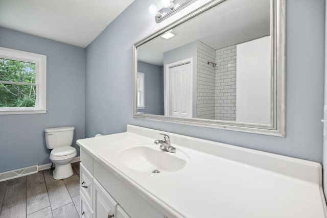 full bath with a shower, visible vents, toilet, vanity, and baseboards