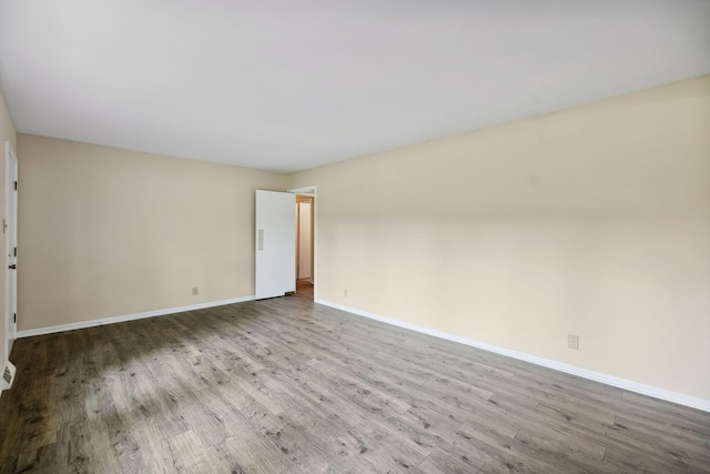 unfurnished room with wood finished floors and baseboards