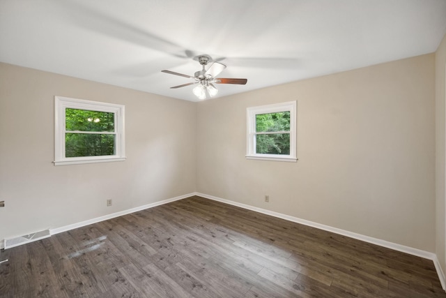 spare room with plenty of natural light, visible vents, and baseboards