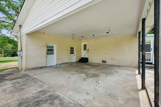 view of patio / terrace featuring entry steps, driveway, and an attached carport