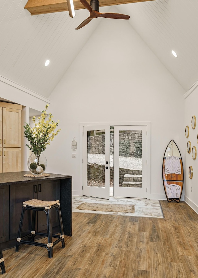 interior space featuring high vaulted ceiling, recessed lighting, baseboards, and wood finished floors