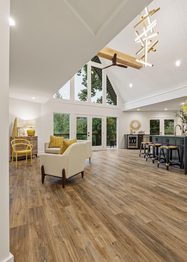 living room with french doors, recessed lighting, a ceiling fan, wood finished floors, and high vaulted ceiling