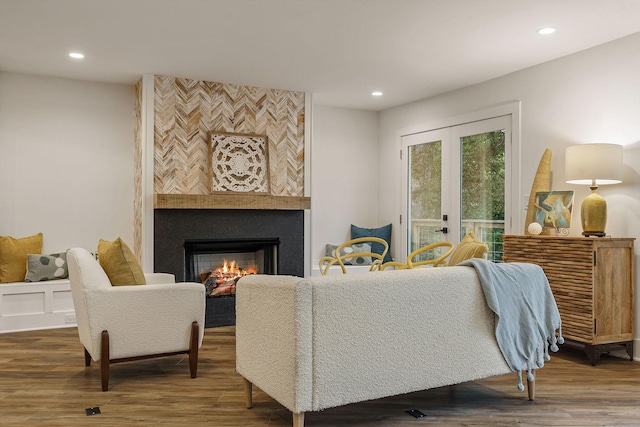 living area with french doors, a fireplace, wood finished floors, and recessed lighting