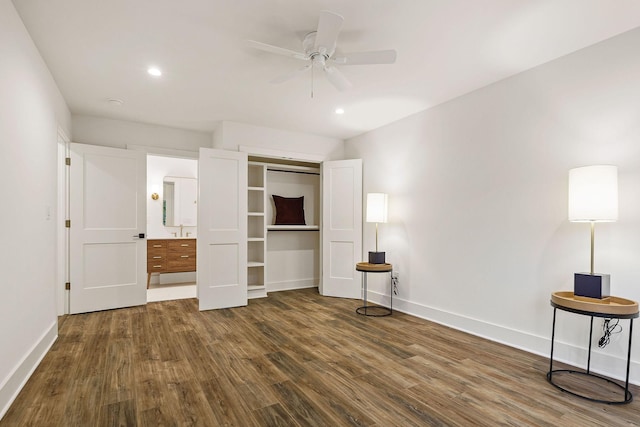 unfurnished bedroom featuring recessed lighting, a sink, wood finished floors, baseboards, and a closet