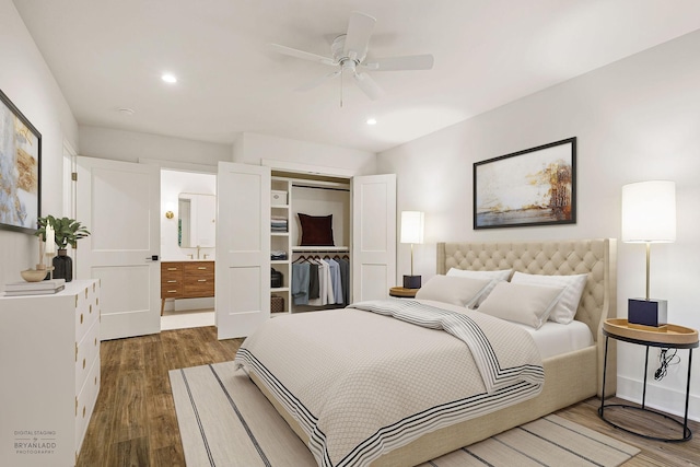 bedroom with a ceiling fan, wood finished floors, ensuite bathroom, a closet, and recessed lighting