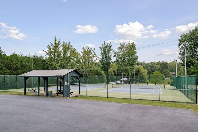 view of tennis court featuring fence