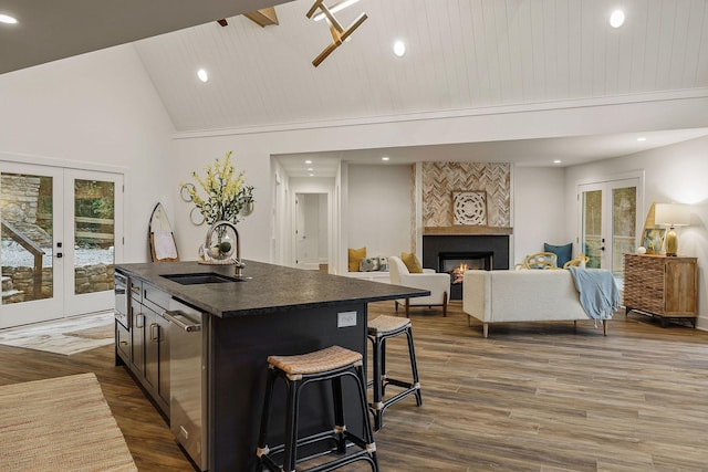 kitchen featuring dark wood-style floors, french doors, dark countertops, and a sink