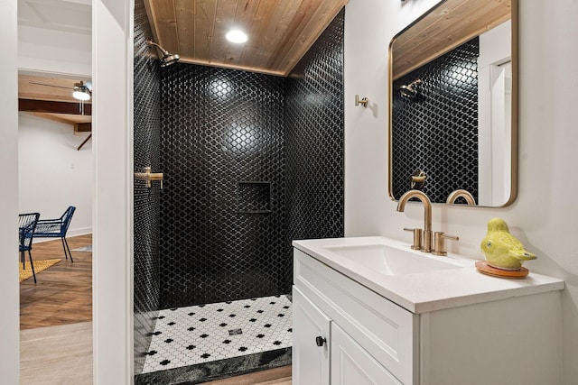 full bathroom featuring a stall shower, wooden ceiling, vanity, and wood finished floors