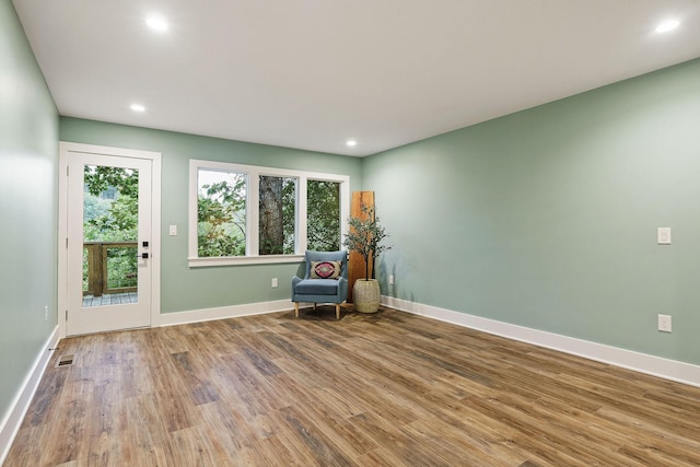 unfurnished room featuring recessed lighting, visible vents, baseboards, and wood finished floors