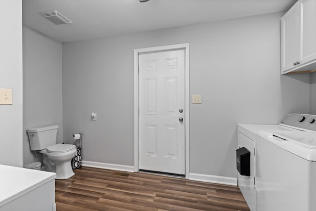 laundry area with laundry area, dark wood-type flooring, visible vents, baseboards, and washing machine and clothes dryer