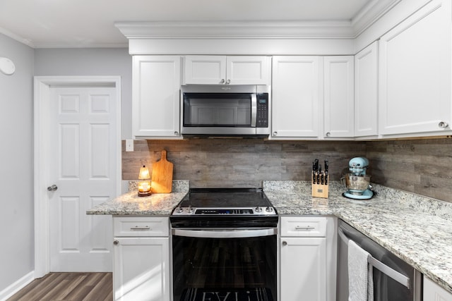 kitchen with appliances with stainless steel finishes, wine cooler, white cabinets, and tasteful backsplash