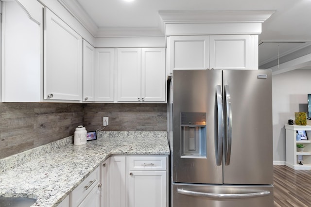 kitchen featuring backsplash, stainless steel fridge, white cabinets, and crown molding