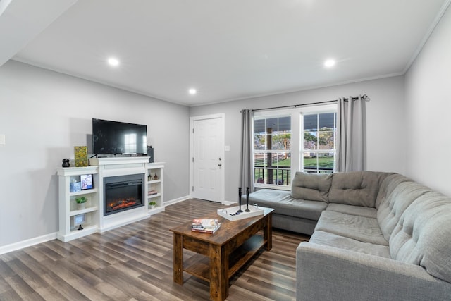 living room featuring recessed lighting, baseboards, dark wood finished floors, and a glass covered fireplace